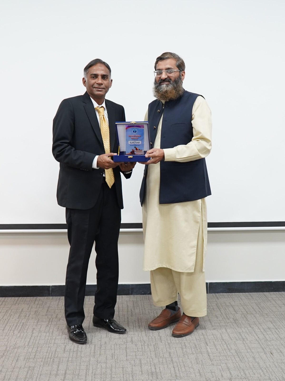 Zulfiqar Ali Qureshi receiving recognition at a capacity building workshop